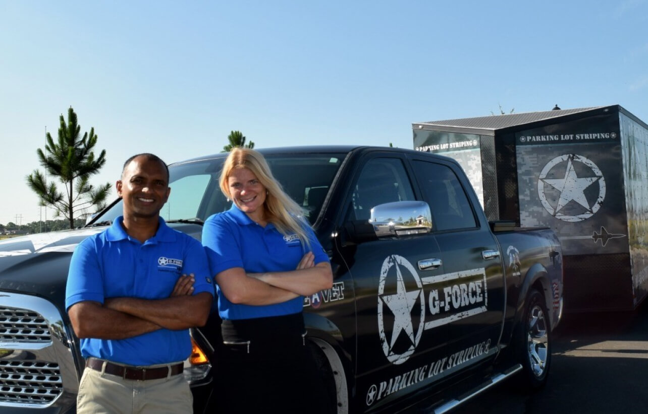 g-force franchisees pose in front of truck